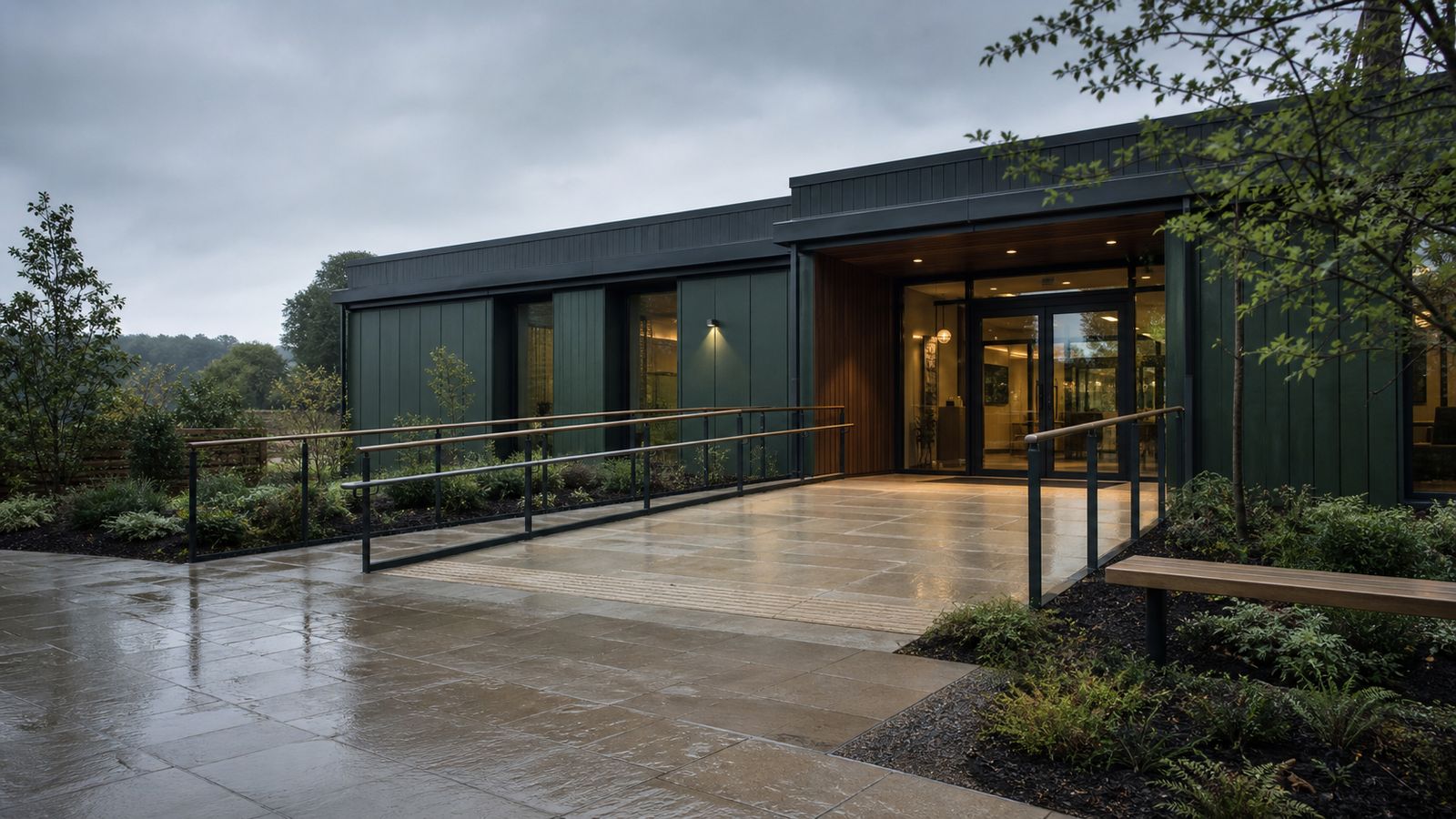 Contemporary modular entrance with a level approach, gentle ramp and dual handrails